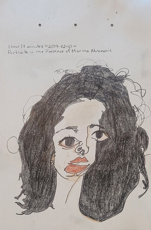 Sketch of a woman with large eyes, prominent lips and messy black hair